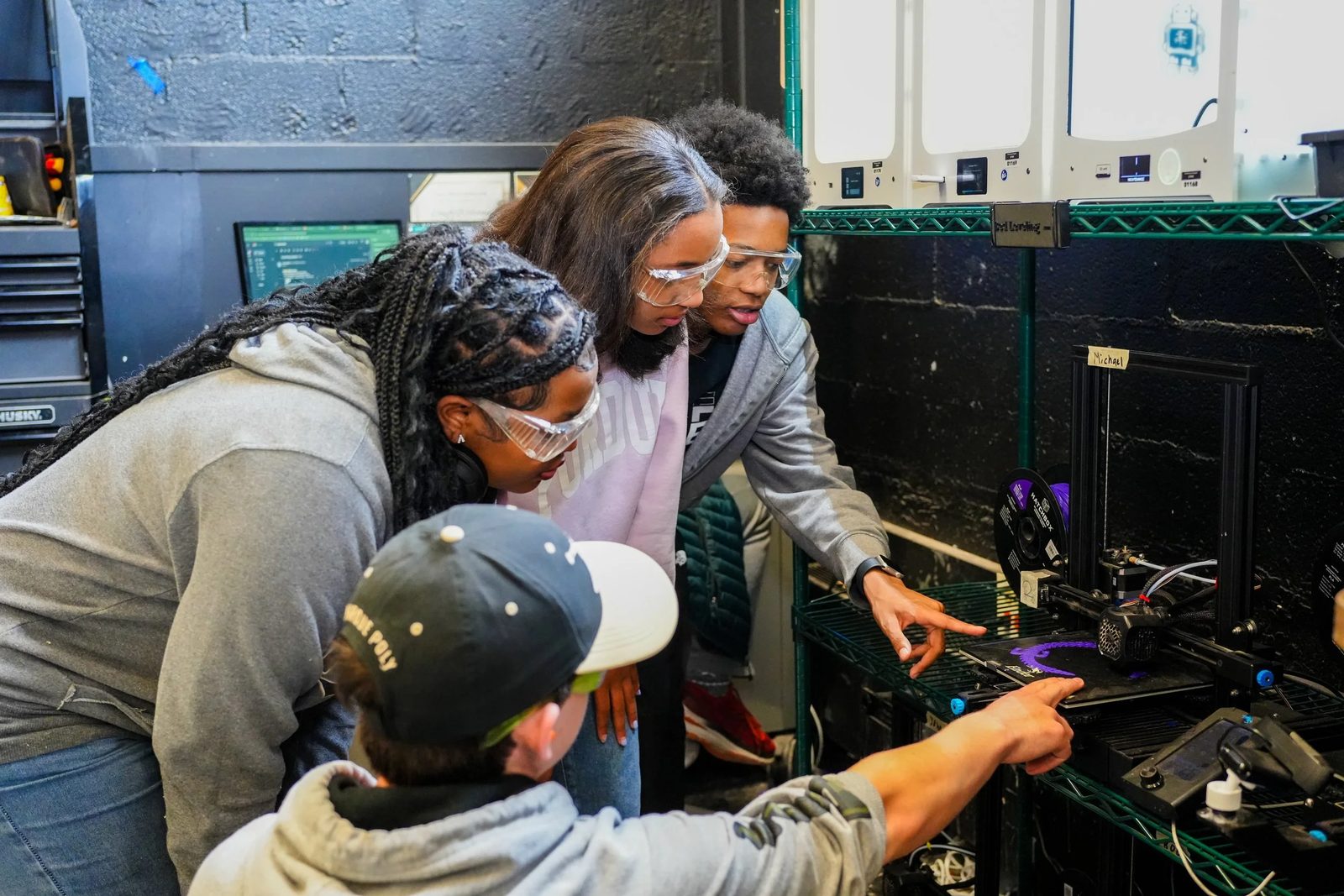 Purdue Polytechnic High School Englewood students working together at a lab bench with a teacher.